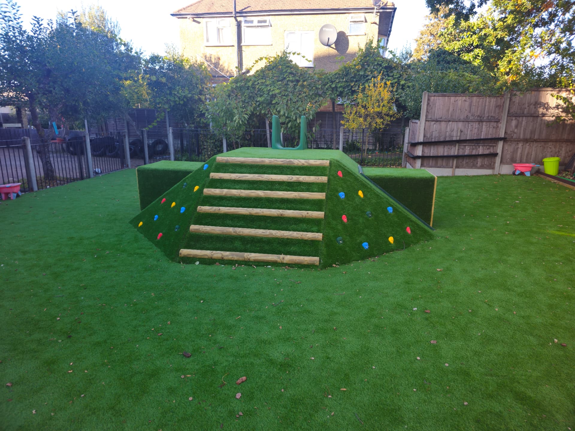 Our Mount Kilimanjaro outdoor play structure with steps, climbing holds, tunnel and slide