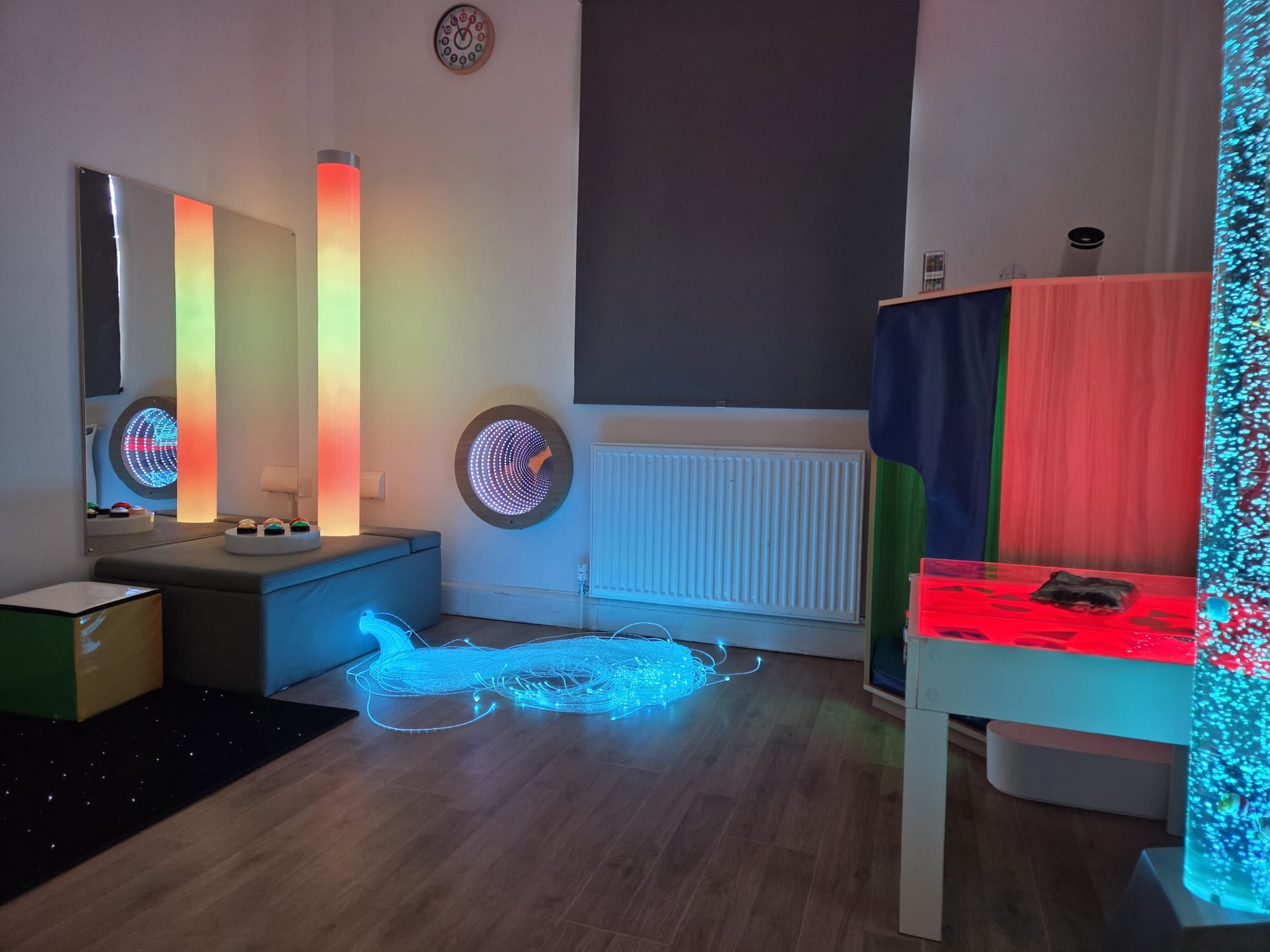 The sensory room with colour-changing light columns, an infinity mirror, a fibre-optic light spray and a bubble tube